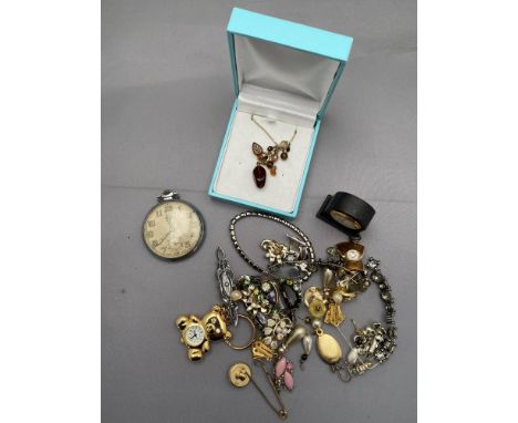 A mixed lot of costume jewellery to include necklaces, earrings, brooches, Smiths pocket watch, miniature mantel clock 