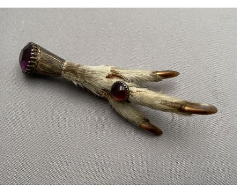 A claw brooch with inset amethyst 