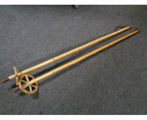 A pair of vintage bamboo and wicker ski poles 