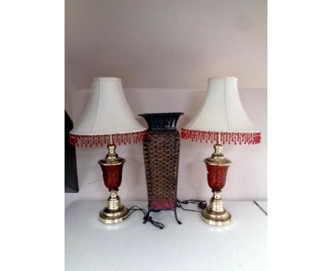 A pair of contemporary table lamps with tasseled shades together with a metal and wicker stick stand 