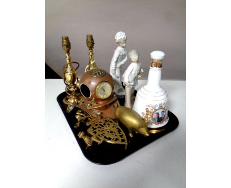 A tray containing miscellaneous to include a copper and brass diver's helmet fitted a clock, brass trivet and table lamps, Wa