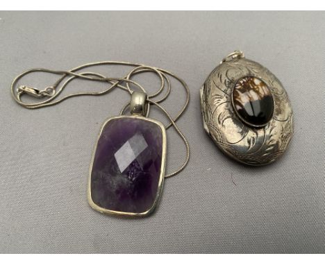 A vintage silver locket together with an amethyst pendant on chain 