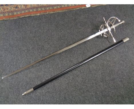 A reproduction sword in scabbard together with a pair of framed monochrome aviation prints 