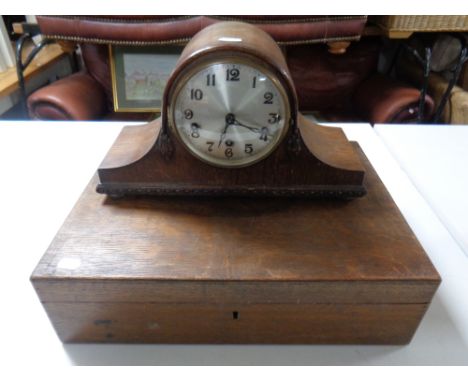 An Edwardian oak cutlery canteen together with an oak cased mantel clock with silvered dial 