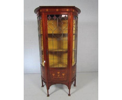 Arts and Crafts display cabinet with shaped front and sides. The top frieze panel inlaid with copper and Mother of Pearl moti