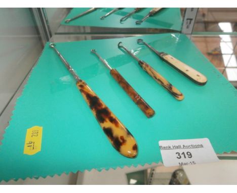 3 tortoise shell & 1 bone retractable button hooks