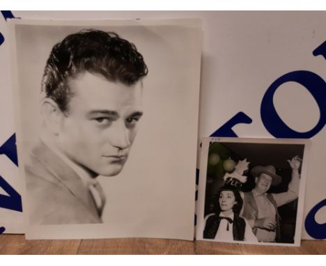 JOHN WAYNE VINTAGE PRESS PHOTOS ONE BEING A YOUNG PORTRAIT 26 X 20.5CM THE OTHER WITH HIS WIFE PILAR PALLETTE