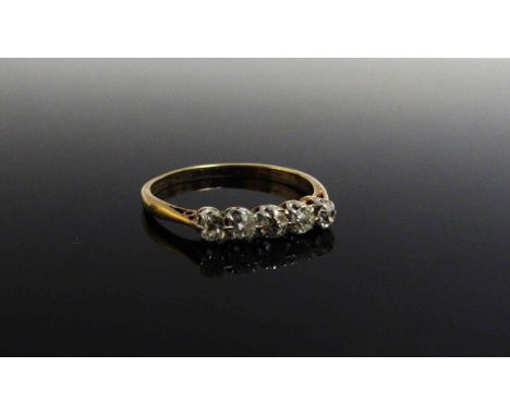 A five stone diamond ring, stamped 18ct Plat. Size R, 2.2g