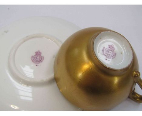 A Royal Worcester porcelain miniature teacup and saucer decorated by Stinton