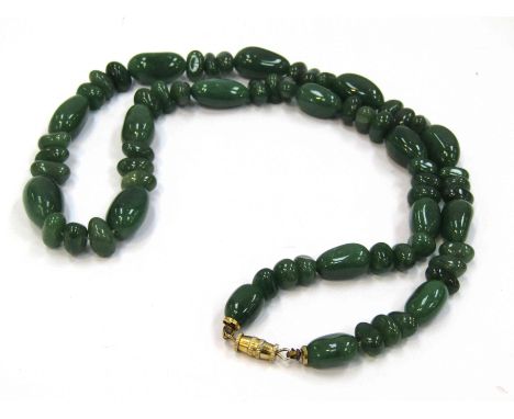 A green jade bead necklace, 60cm long