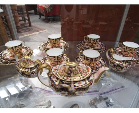 A composite Royal Crown Derby pattern 2451 Imari tea set consisting of six tea cups, six saucers, four tea plates, four side 