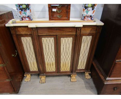 A Regency rosewood sideboard, breakfront form with wirework and silk doors opening to reveal shelf space, on gilded lion paw 