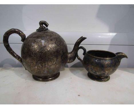 A Chinese Wan Hing silver teapot and milk jug, bamboo leaf design, stamped to base with 90, 736g 