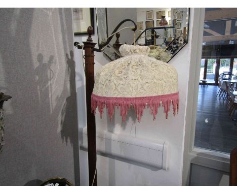 A reeded columns standard lamp with overhanging shade