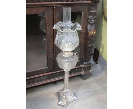 A Victorian silver plate oil lamp with shade, column base, 76cm tall