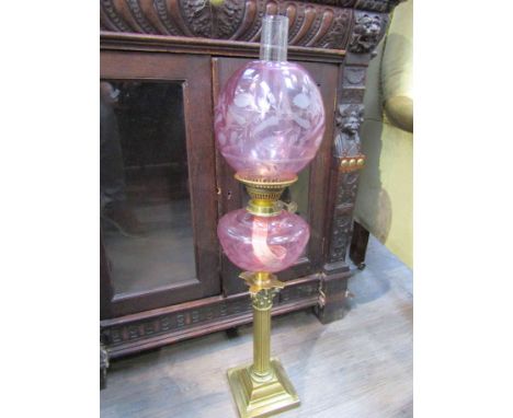 A Victorian pink oil lamp and shade, with globular shade, 77cm tall