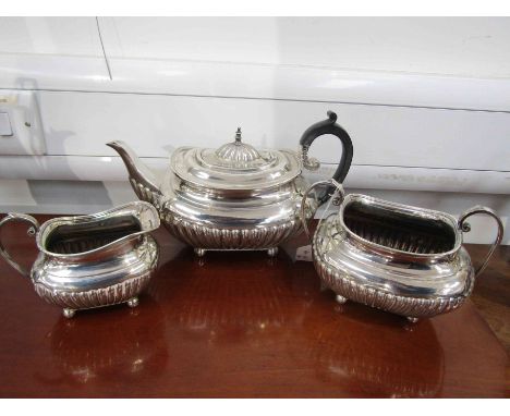 A James Dixon &amp; Sons silver three piece teaset, teapot, milk jug and sucrier, fluted design, ball feet, Sheffield 1909/19