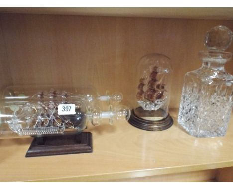 Three ship in bottle glass ornaments and a Stewart crystal decanter 