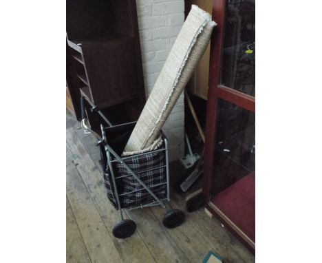 A new fold up light weight shopping trolley and 3 small rugs 