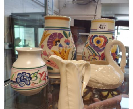 A Belleek swan ornament, small jug and 3 Poole Pottery vases 