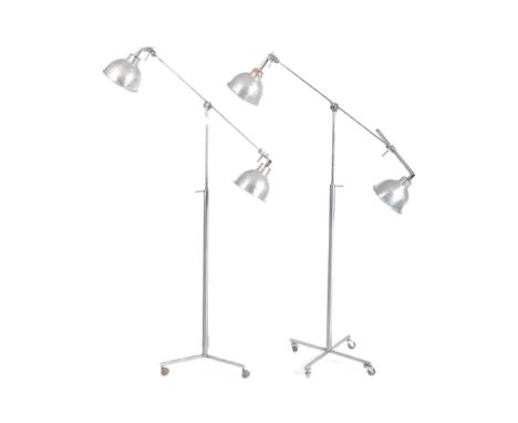 A matching pair of retro 20th Century industrial adjustable lamp light stands each with&nbsp;twin arm having polished alumini