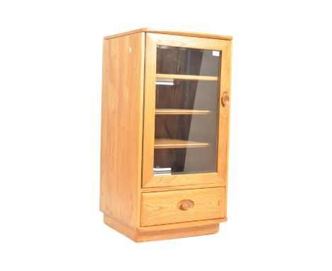 Ercol - A Contemporary beech and elm media / hi-fi upright pedestal cabinet having a hinged lid with glazed frontend door bel