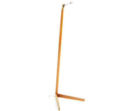 A retro 20th Century teak and brass atomic floor standing lamp light having and adjustable brass arm upon a onepiece stem sup
