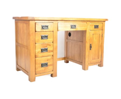 A Modern solid light oak twin pedestal office desk having a chunky oak top with central fall front section over a knee hole r