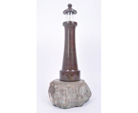 A retro vintage 20th century&nbsp;Cornish carved serpentine marble lighthouse table light upon a Cornish granite base. Lighth