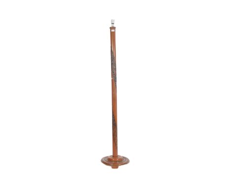 A retro 20th century carved teak standard lamp light having a two piece teak column carved with dragons and foliate detailing
