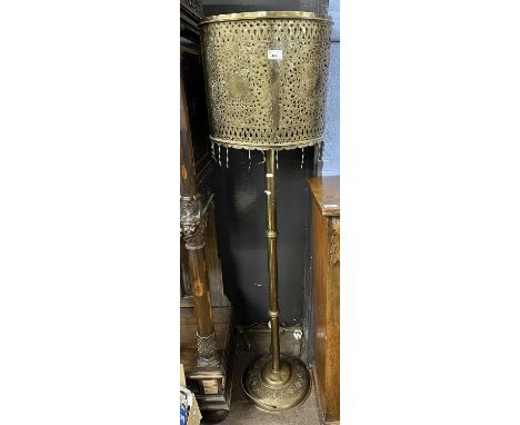 An Oriental brass standard lamp with unusual pierced brass shade (Item 23 on vendor list)