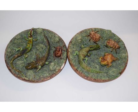 A small pair of Portuguese Caldas pottery palissy style plates decorated in relief with dragons, lizards and frogs, 18cm diam