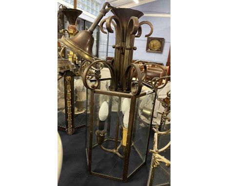 A 20th Century hexagonal three light ceiling lantern with glass panelled sides and bronzed metal frame, 53cm high