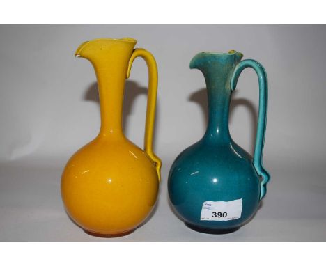 Two Linthorpe pottery glazed ewers, shape number 826 after Christopher Dresser Designs, 18cm high (chip to spout of one)