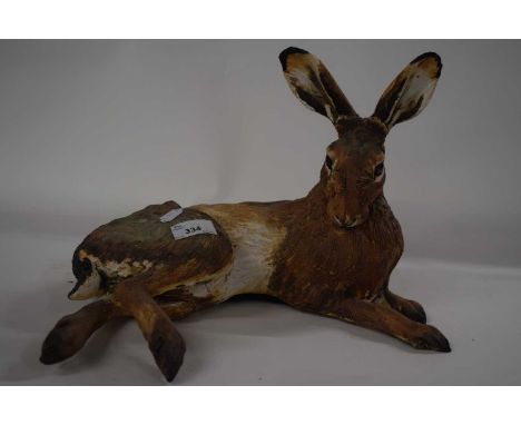 A ceramic sculpture of a rabbit in naturalistic colours