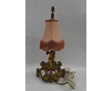 A gilt brass table lamp with porcelain panels