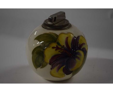 A Moorcroft Pottery table lighter, the white ground with hibiscus decoration with paper label to base