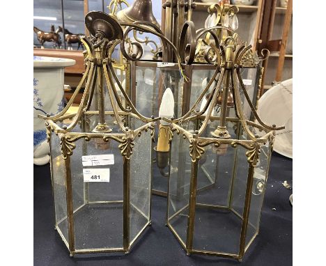 A pair of small brass mounted hexagonal ceiling lantern light fittings with panelled glass sides, 34cm high