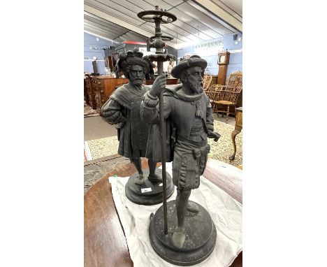 A pair of late 19th or early 20th Century Spelter lamp bases formed as medieval figures raise on turned wooden bases, lacking