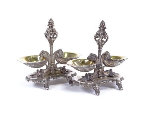 A pair of 19th century cast French silver Rococo style table salts, with gilt shell design bowls and dolphin supports, stampe