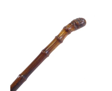 A square section bamboo walking cane, with Solingen steel blade, length 90cm.Splits on two sides of top section of bamboo she