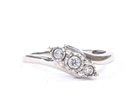 An unmarked white gold 3-stone diamond crossover ring, set with round brilliant cut diamonds in illusion settings, total diam