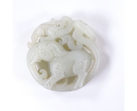 A Chinese relief carved and pierced jade elephant design pendant, 5cm across 