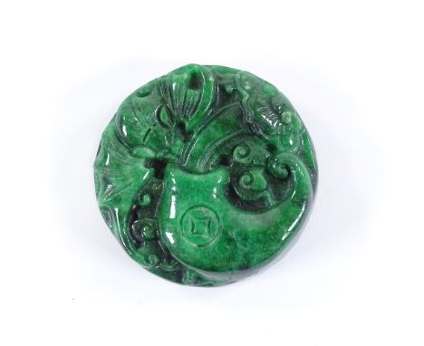 A Chinese relief carved jade circular pendant, 4.5cm across 