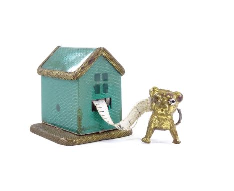 A Vintage novelty pressed metal dog kennel design sewing tape measure, height 3cm 