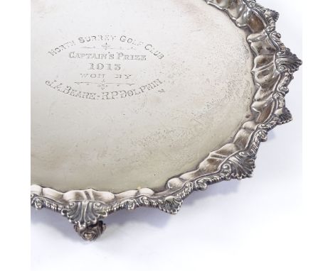 A George V circular silver salver, scalloped shell rim with scrolled acanthus feet, by Harrison Brothers & Howson, hallmarks 