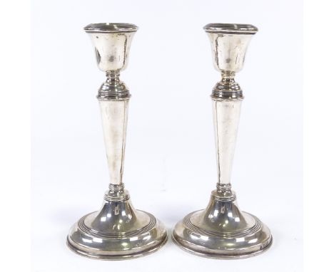 A pair of George V silver table candlesticks, tapered stem with reeded decoration, by William Hutton &amp; Sons Ltd, hallmark