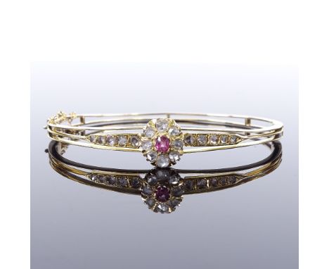 A Victorian unmarked gold pink topaz and rose-cut diamond cluster hinged bangle, pierced settings, cluster panel height 11.2m