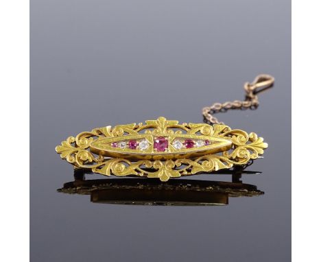 A Victorian 15ct gold ruby and diamond marquise brooch, pierced and chased scrollwork settings, brooch length 45.2mm, 5.4gVer