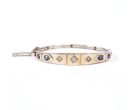 A Victorian unmarked gold sapphire and diamond hinged bangle, floral engraved bridge, total diamond content approx 0.4ct, set